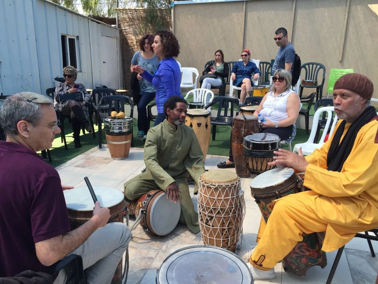 Community drumming circle with children and elders