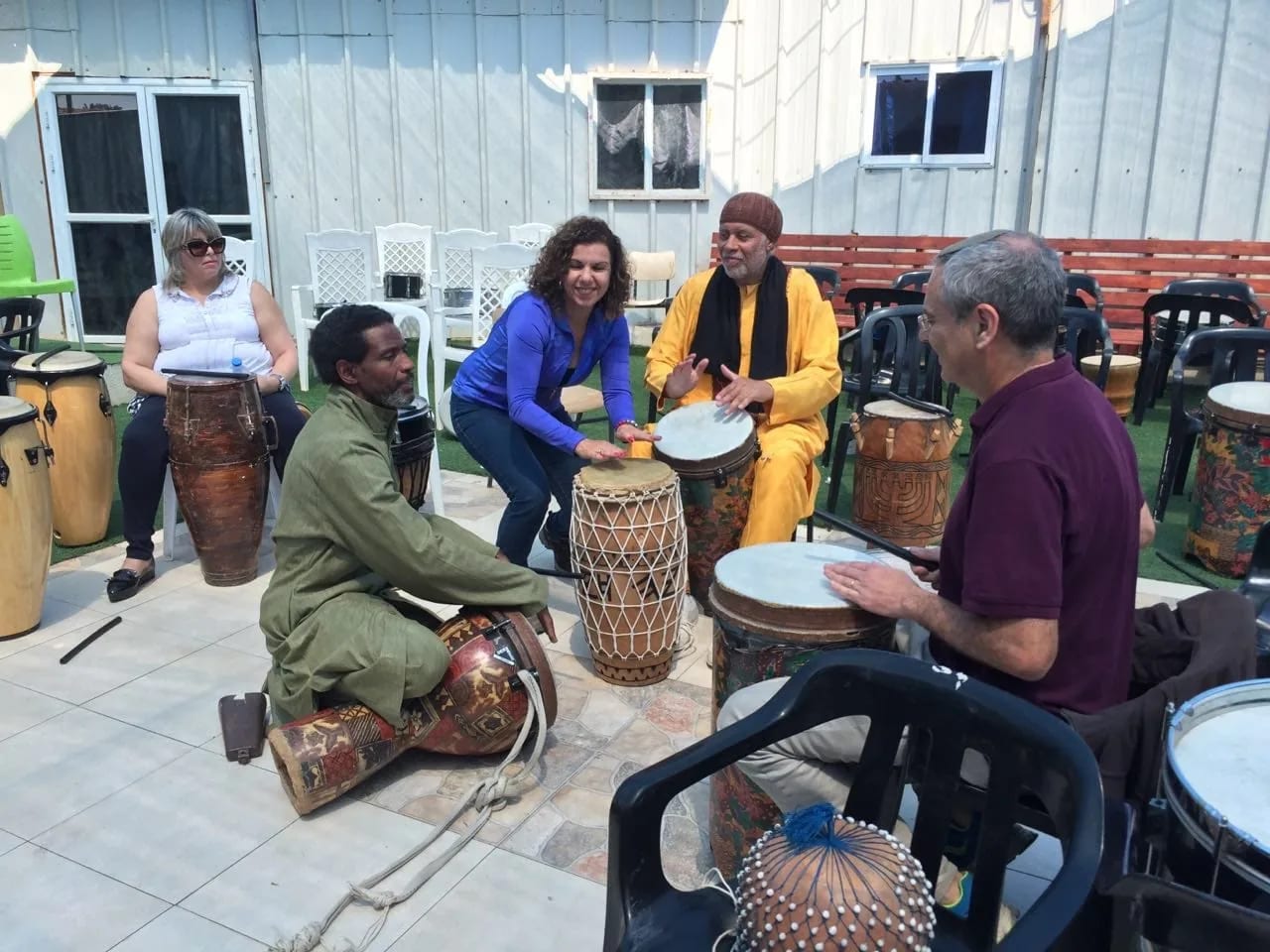 Drumming class with children and adults in the Village of Peace