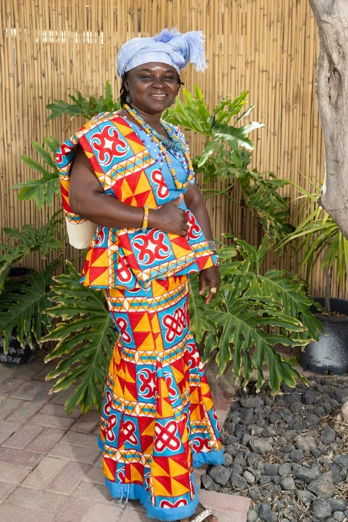 Elder woman in colourful dress at a Village of Peace gathering