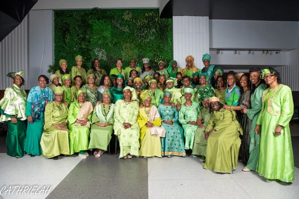 Community members gathered in coordinated green garments