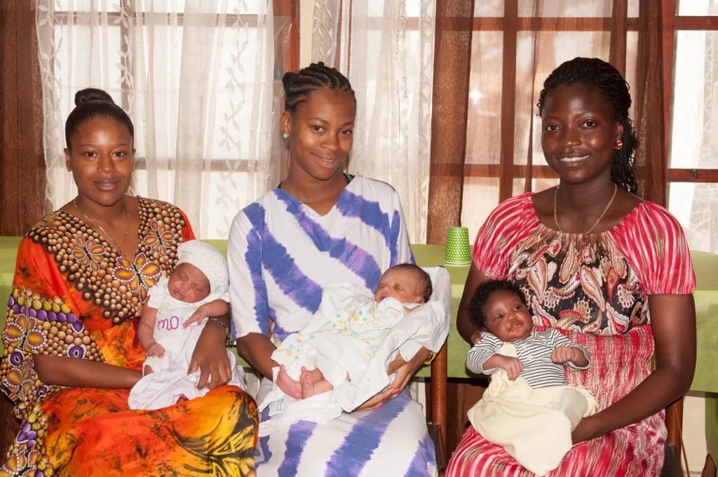 Mothers holding babies in the Village of Peace